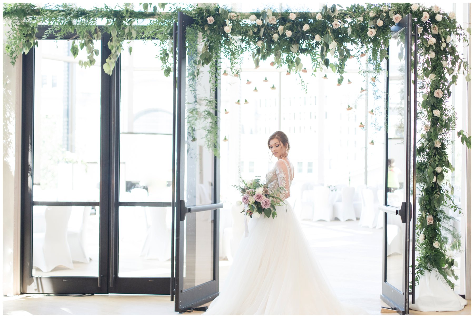 Fairytale wedding with lots of florals - Flower doorway arch by Capital Florist- Bride with white Nicole Spose’s dress from Sinders Bridal at Ottawa's NAC O'Born room wedding venue: The Barnett Company - Ottawa Wedding Photographer