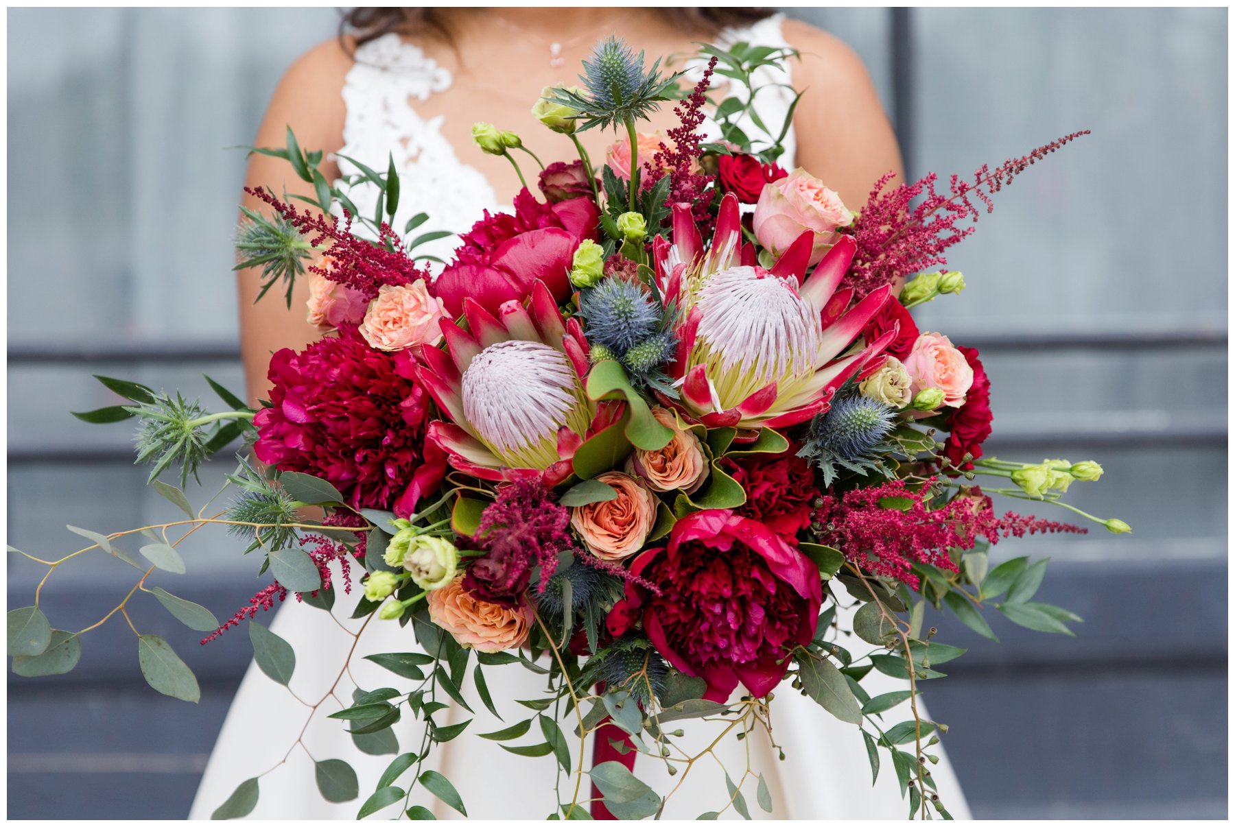 Red protea and peonies bouquet