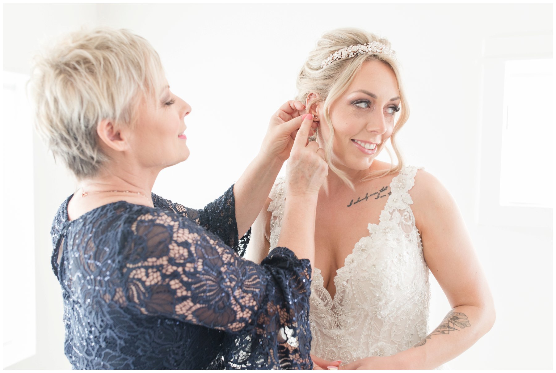 mother putting bride's earrings