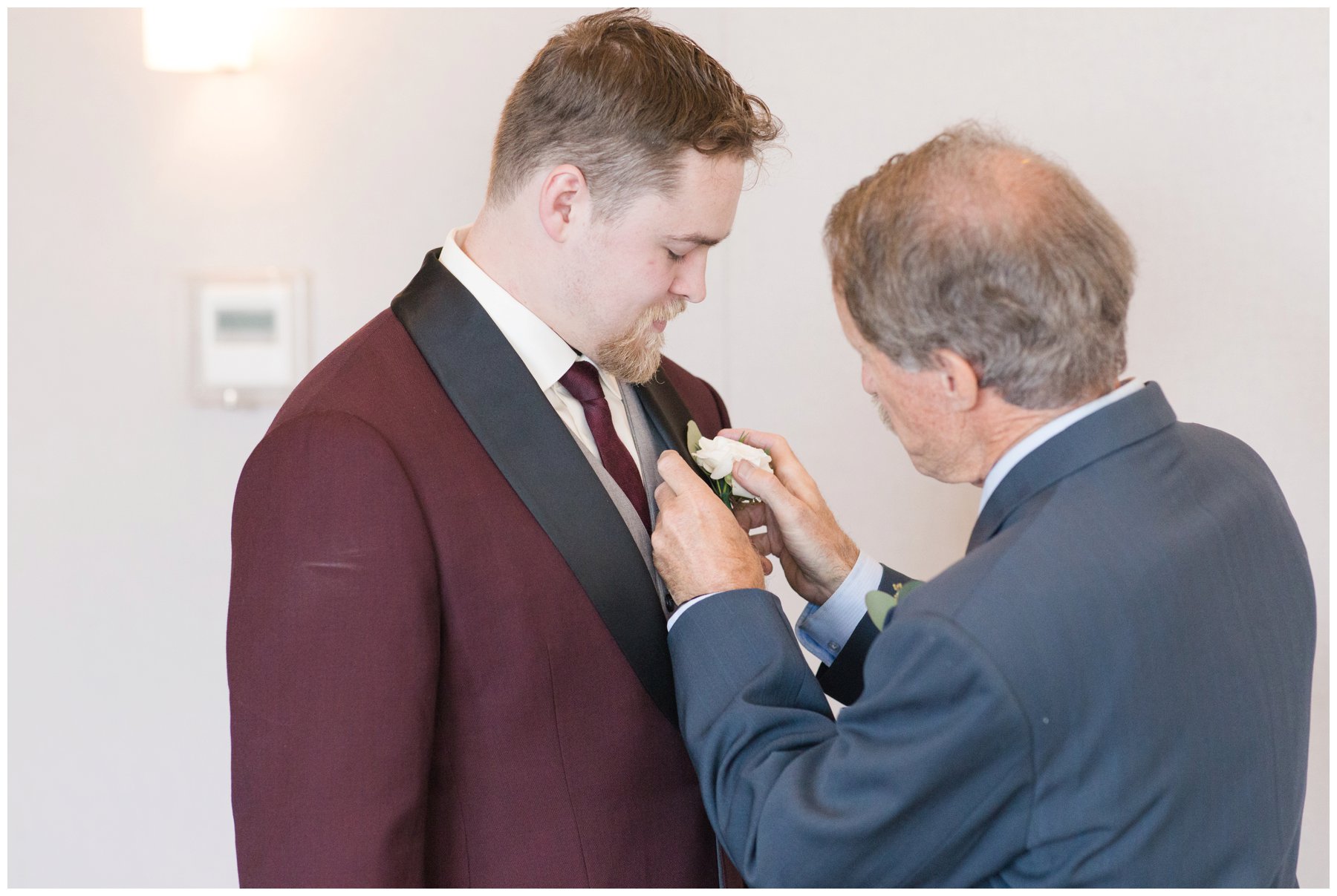 dad helping groom with tie at Le Belvedere