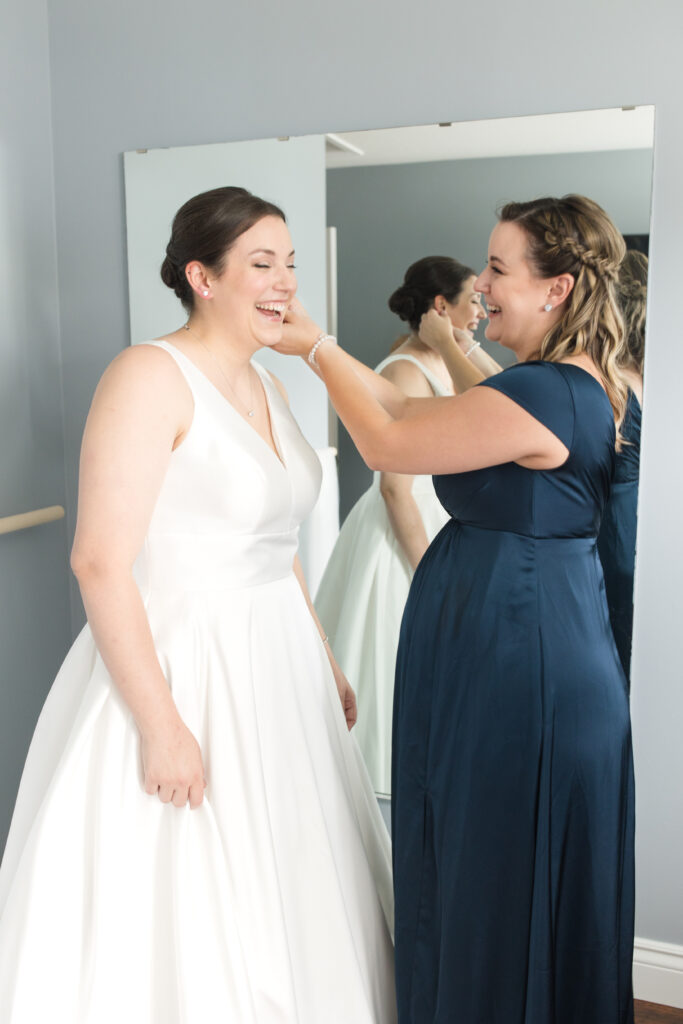 Bride and sister getting ready for her wedding